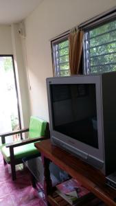 a television sitting on a table in a living room at Blue Mountain Resort in Sai Yok