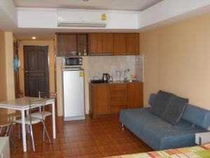a living room with a couch and a table and a kitchen at Jomtien beach Condominium S2 in Jomtien Beach