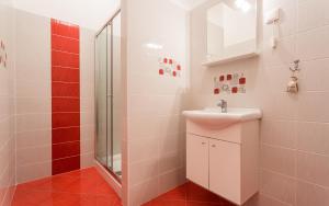 a bathroom with a sink and a shower at Apartments Kraljić in Baška +26 photos