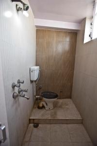 e bagno con servizi igienici in una cabina. di Namaskar Hotel a Nuova Delhi