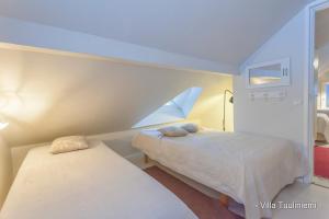 Ένα ή περισσότερα κρεβάτια σε δωμάτιο στο Villa Tuuliniemi