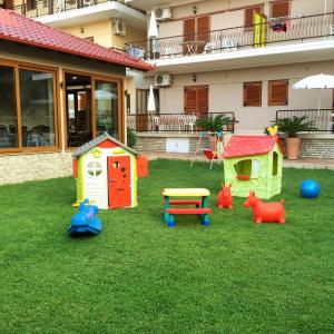 a yard with play equipment on the grass at Vaya Apartments & Studios in Platamonas
