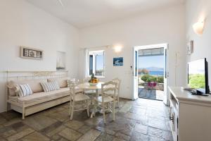 a living room with a couch and a table at Ambelas Mare Apartments in Ambelas