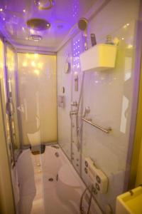 a bathroom with a toilet and a purple lighting at Two Top Central Unique Artisan Beach Studios - also separate spa cabin in Brighton & Hove