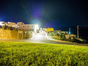 an empty street at night with lights on at Tenerife Climbing House in Lomo de Arico