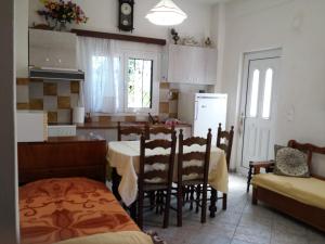 a kitchen with a table and chairs and a dining room at Paradise City studios in Loutraki