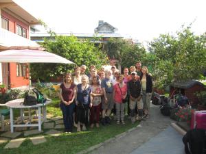a group of people posing for a picture in a yard at New Annapurna Guest House in Pokhara