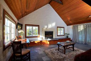 a living room with a fireplace and a table at Sky Harbour in Kaikoura