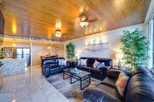 a living room with leather couches and a table at Central Waikiki Luxury Penthouse in Honolulu