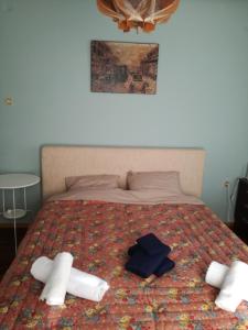 a bed with two pillows and towels on it at Nicolas Dream in Nea Makri