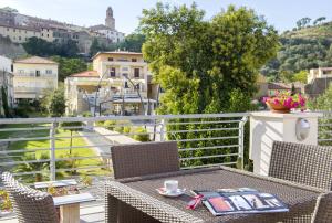 a table and chairs on a balcony with a view at Cav Brunella in Castiglione della Pescaia