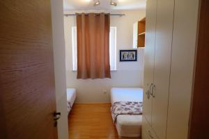 Postel nebo postele na pokoji v ubytování Apartments Kovacic