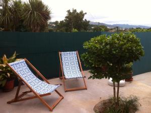 two chairs sitting on a patio next to a fence at Casas da Nazare in Ponte de Lima