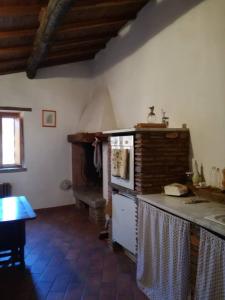 a kitchen with a counter and a stove in a room at Casamatta a Blera in Blera