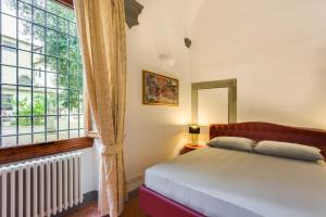 A bed or beds in a room at Residenza d'Epoca Galleria dell'Accademia