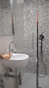 a bathroom with a sink and a shower at Taverna del Capitano Rooms in Vernazza