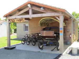 a garage with bicycles parked in front of it at Gîte Relais du Doulay in Saint-Fulgent