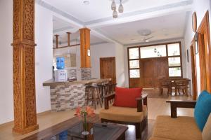 a living room with a fireplace and a table at Tea Hills Bungalow in Hatton +37 photos