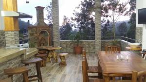 a dining room with a table and a fireplace at Tea Hills Bungalow in Hatton
