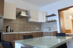 a kitchen with a table and chairs in a kitchen at Panorama Mediterranea in St Paul's Bay