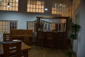a room with a table and chairs and a bar at Tea Hills Bungalow in Hatton