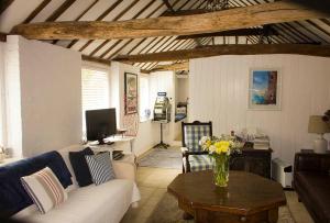 a living room with a couch and a table at The Studio @ Great Streele Cottage in Uckfield