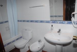 a bathroom with a white toilet and a sink at Apartaments Bonaventura 7 in Sitges