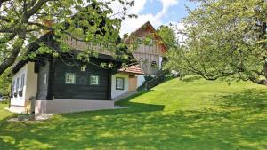 una casa en un patio de césped con un edificio en Winzerhaus im Schilcherland en Steinreib