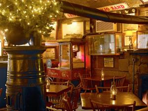 a restaurant with tables and chairs and a train at The Griswold Inn in Essex