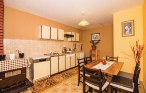 a kitchen and dining room with a table and chairs at Holiday Home Paul in Blace