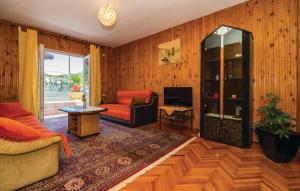 a living room with a couch and a chair at Holiday Home Paul in Blace