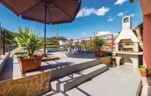 a patio with a fireplace and an umbrella at Holiday Home Paul in Blace