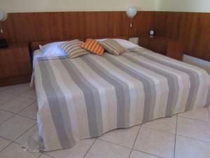 a large bed with two pillows on top of it at Apartment Petrović in Korčula