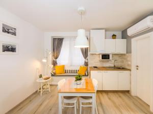 a kitchen and dining room with a table and chairs at Navis Luxury Apartments in Vodice