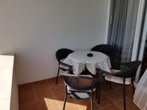 a table and chairs with a white table cloth on it at Apartments Šurjak in Orebić