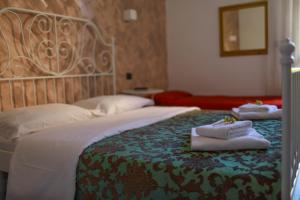 En eller flere senge i et værelse på Hotel Pisa