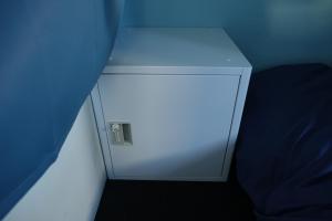 a small white cabinet in a corner of a room at Hostel NABLA in Niijimamura