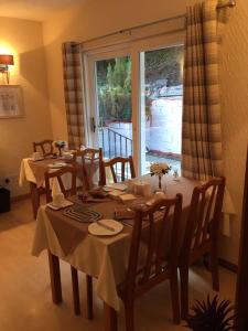 a dining room with a table and chairs and a window at Southfork Villa Guesthouse in Callander