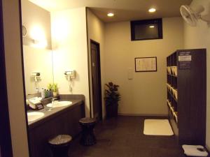 a bathroom with two sinks and a mirror at Hotel Route-Inn Tsuruoka Ekimae in Tsuruoka
