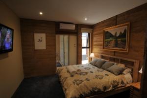 a bedroom with a bed and a picture on the wall at Beach House Dunsborough in Dunsborough