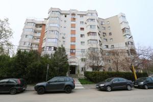 a group of cars parked in front of a building at Apartament Erika - by the beach in Constanţa