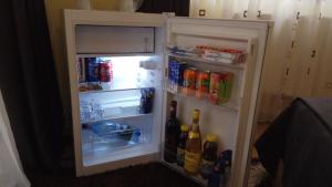 an open refrigerator filled with drinks and drinks at Casa Adina in Sinaia