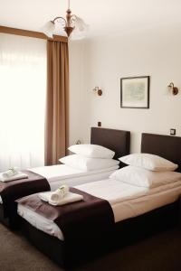 Łóżko lub łóżka w pokoju w obiekcie Hotel Eden