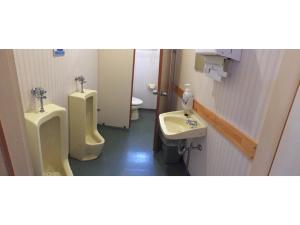 a bathroom with two urinals and a sink at Kagura House in Yuzawa