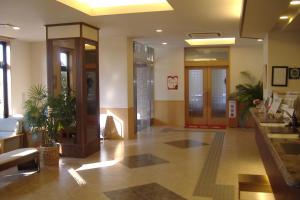 a lobby of a building with a hallway with a lobby at Hotel Route-Inn Nagaoka Inter in Nagaoka