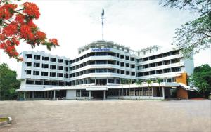 a large white building with a flag on top of it at Lam Nghiep Do Son Hotel in Ðố Sơn