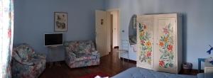 a living room with a tv and a couch and a chair at Arco di San Francesco in Atri