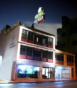 a building with a neon sign on top of it at Hotel Premier Saltillo Coahuila in Saltillo