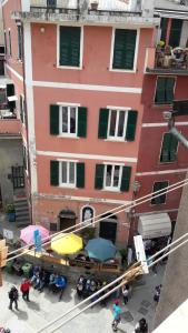a group of people standing in front of a building at Taverna del Capitano Rooms in Vernazza
