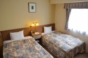 Ένα ή περισσότερα κρεβάτια σε δωμάτιο στο Yokohama Mandarin Hotel